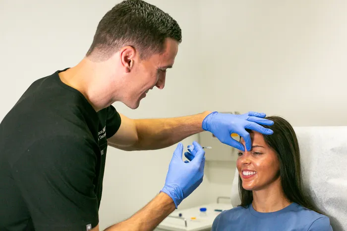 A woman receiving a botox injection