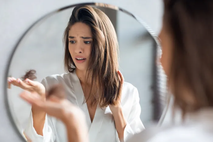 Woman looking distraught at loss of hair