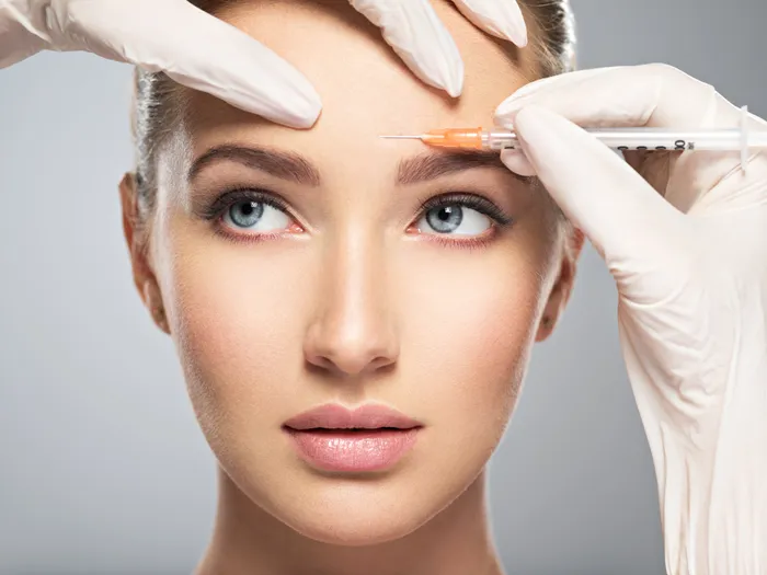 A woman receiving a botox injection