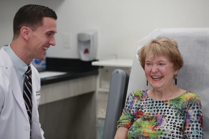 Dr. Hudson explaining procedure to female patient