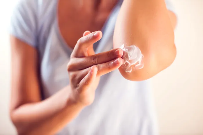 A Person applying ointment to skin