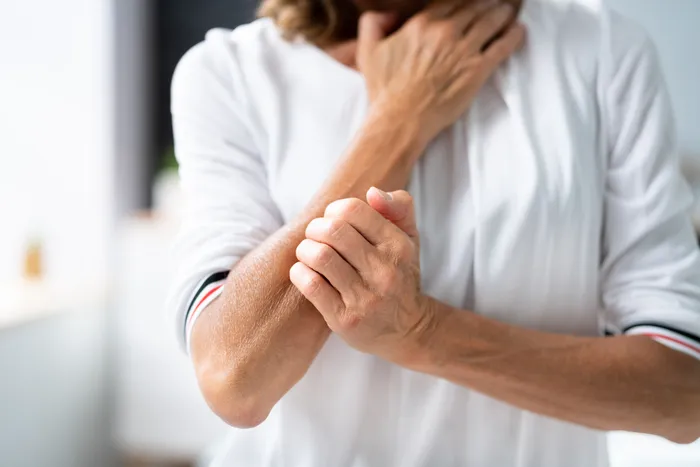 Person scratching itchy skin